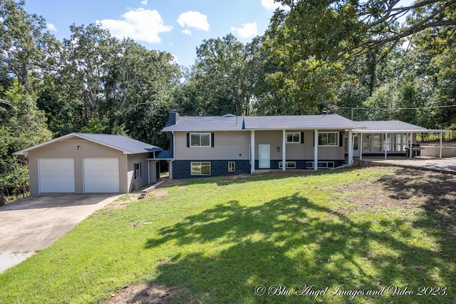 view of front facade with a front yard, a garage, an outdoor structure, and covered porch