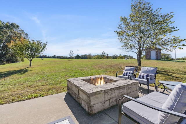 view of patio featuring a shed, a rural view, and an outdoor fire pit