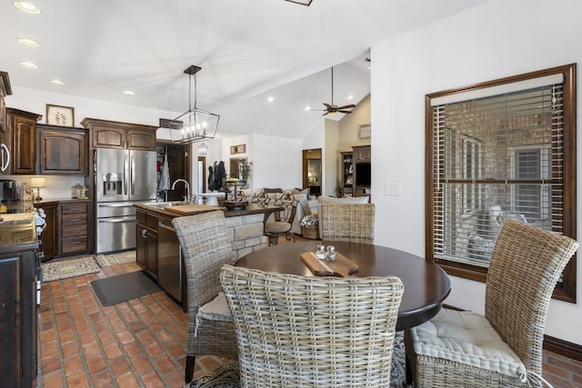 dining room with sink, vaulted ceiling, and ceiling fan