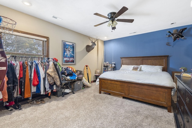 bedroom featuring light colored carpet and ceiling fan