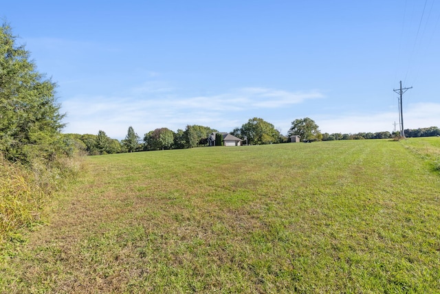 view of yard with a rural view