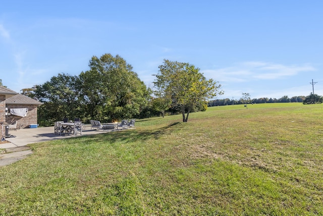 view of yard featuring a patio and a rural view