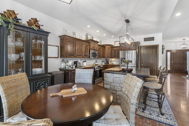 dining area featuring hardwood / wood-style floors and a notable chandelier