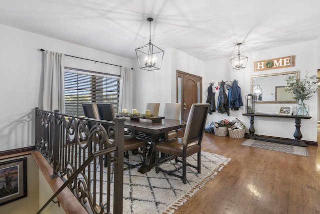 dining space featuring an inviting chandelier and hardwood / wood-style flooring