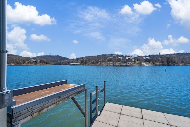 view of dock featuring a water and mountain view