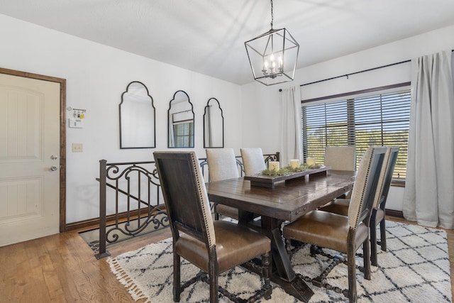 dining room featuring a chandelier and light wood-type flooring