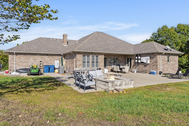 back of house with a lawn and a patio