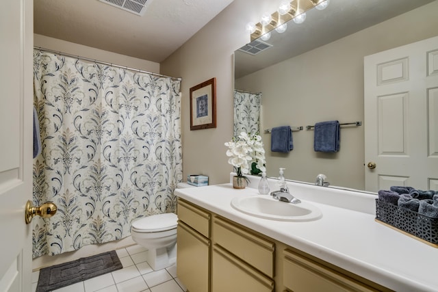 bathroom featuring walk in shower, vanity, toilet, and tile patterned floors