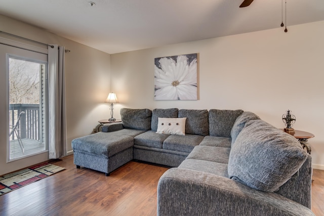 living room featuring hardwood / wood-style floors and ceiling fan