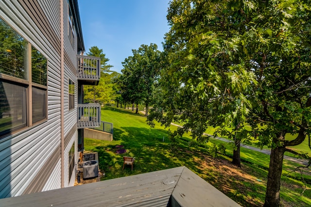 view of yard with a balcony and central AC