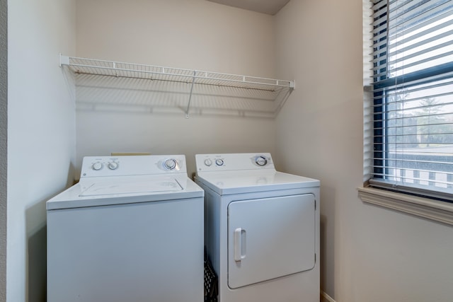 clothes washing area featuring separate washer and dryer