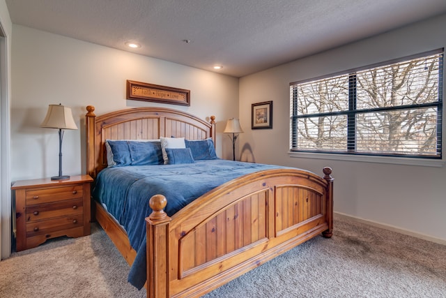 bedroom featuring light colored carpet and a textured ceiling