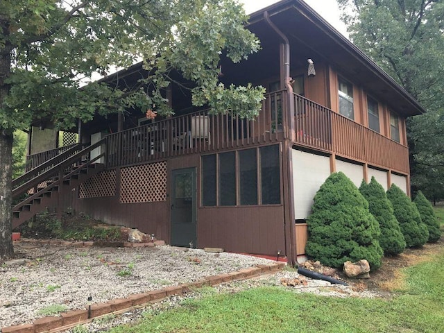 rear view of house with a wooden deck