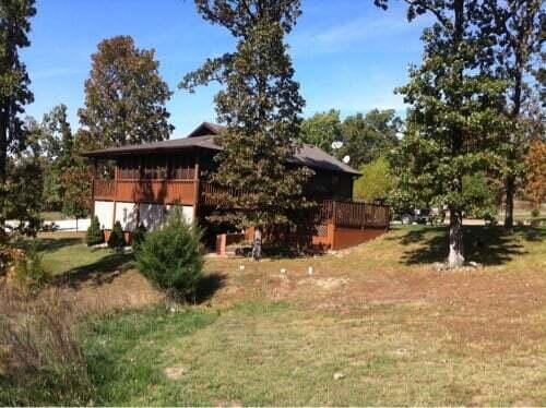 26020 Sharon Ln, Warsaw, MO 65355 - view of side of home featuring a yard and a deck