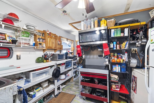 storage room with washer / dryer and ceiling fan