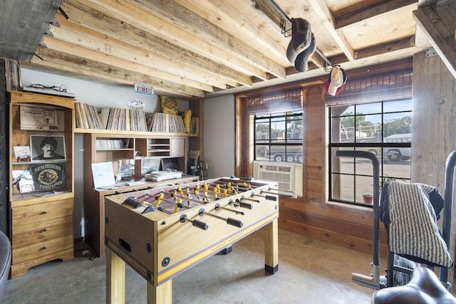 recreation room with wood walls and cooling unit