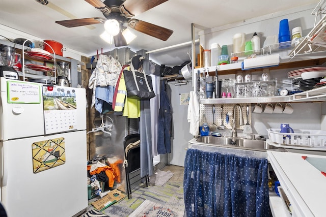 interior space featuring ceiling fan and sink