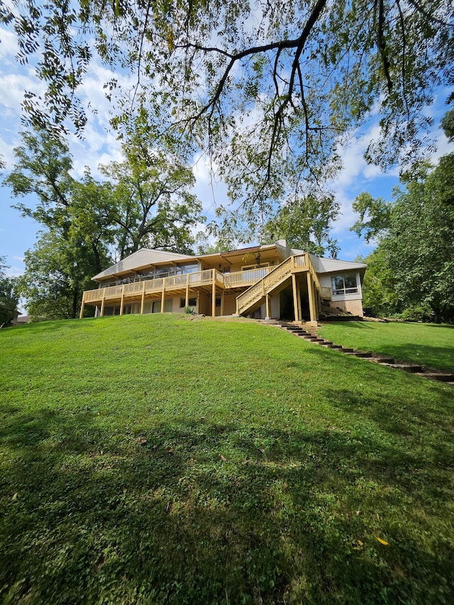 back of house with a yard and a deck