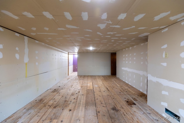 below grade area featuring hardwood / wood-style flooring