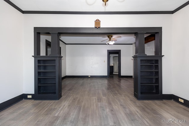 unfurnished living room featuring wood finished floors, a ceiling fan, baseboards, and crown molding