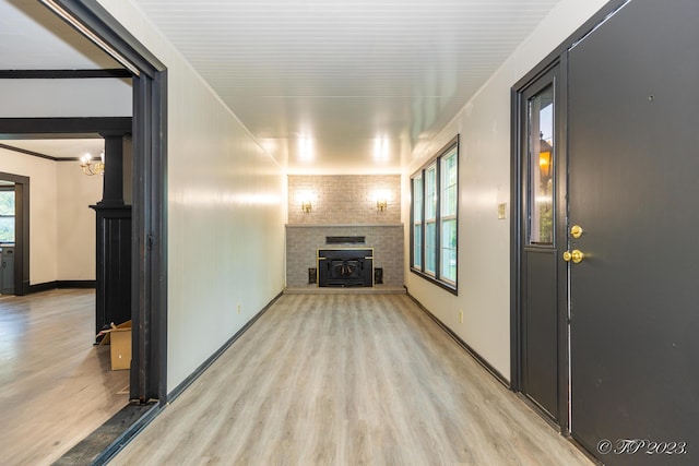 unfurnished living room featuring baseboards, wood finished floors, and a fireplace