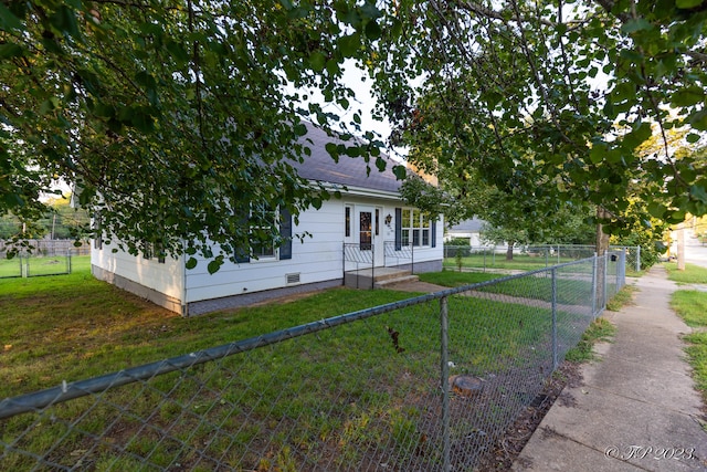 view of front of property with crawl space, a front lawn, a fenced front yard, and a shingled roof