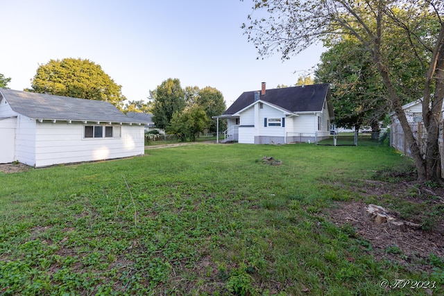 view of yard featuring fence and an outdoor structure