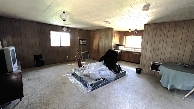 interior space with light carpet, wooden walls, and a wall unit AC