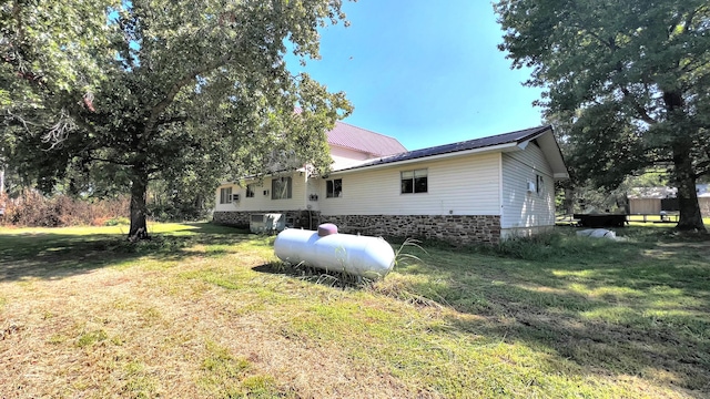 view of side of property with a yard