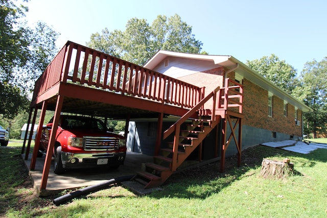 view of side of home with a carport, a yard, and a deck