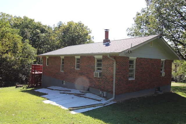 rear view of house with a wooden deck, cooling unit, and a lawn