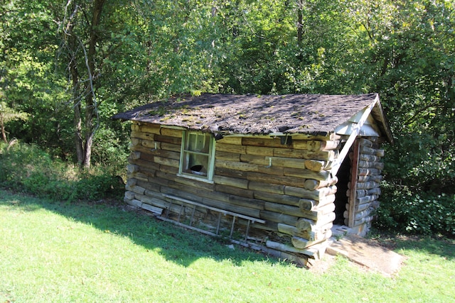 view of outbuilding featuring a yard