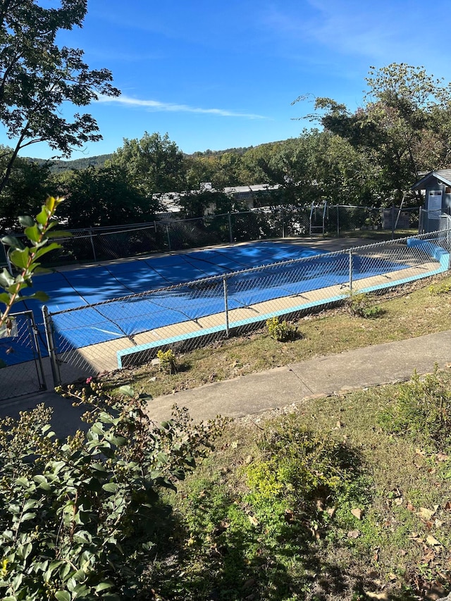 view of pool with tennis court