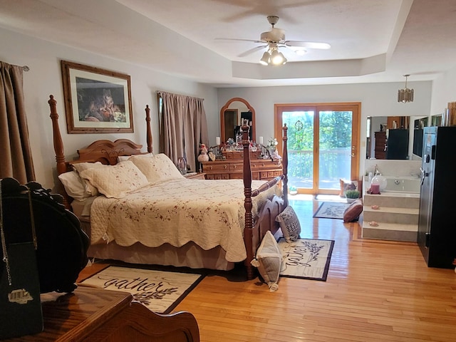 1201 Railey Creek Rd, Reeds Spring, MO 65737 - bedroom with a tray ceiling, light wood-style flooring, a ceiling fan, and access to outside