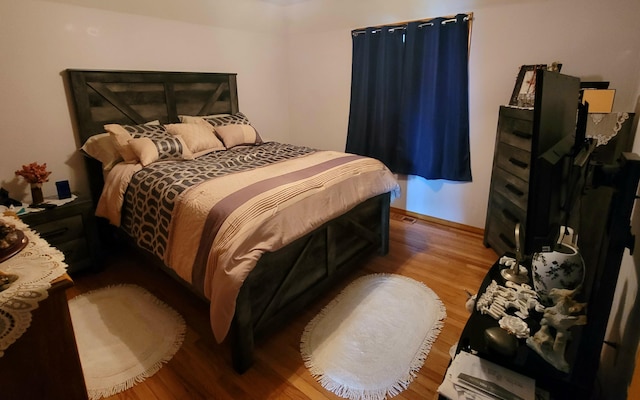 bedroom with hardwood / wood-style floors