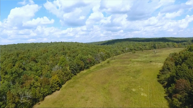 birds eye view of property with a view of trees