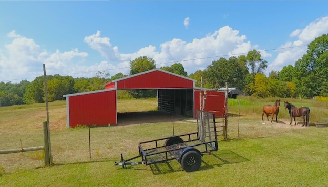 exterior space with an exterior structure, a detached carport, an outbuilding, and driveway