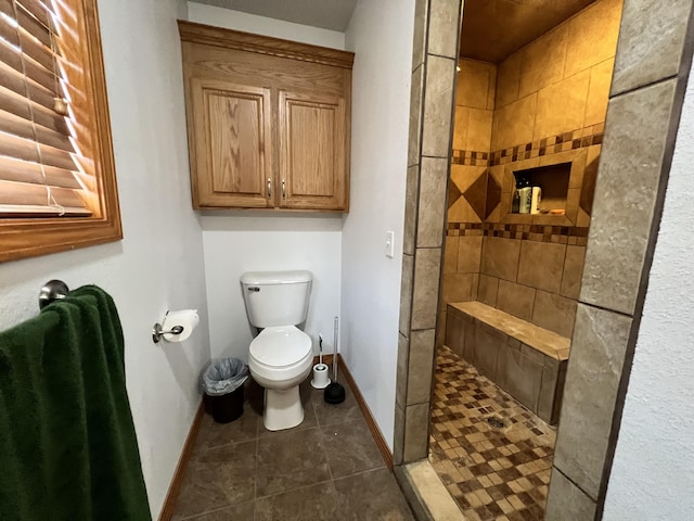 full bath with walk in shower, baseboards, tile patterned flooring, and toilet