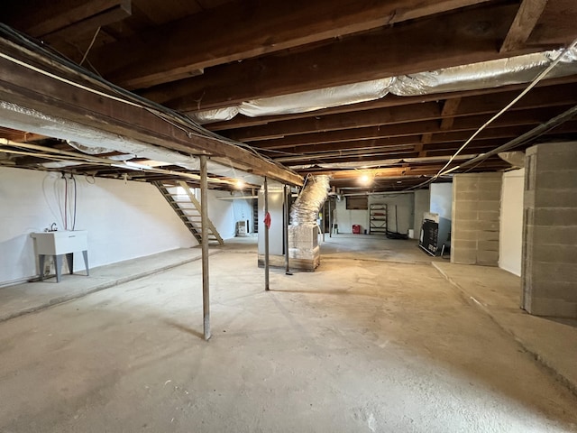 unfinished basement featuring stairs