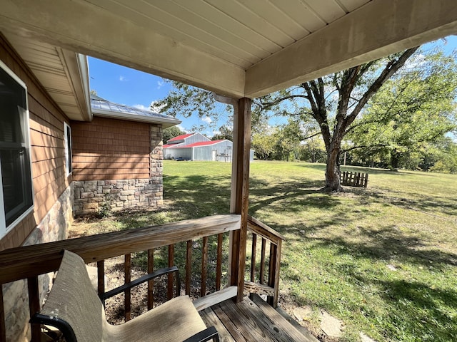wooden deck featuring a lawn