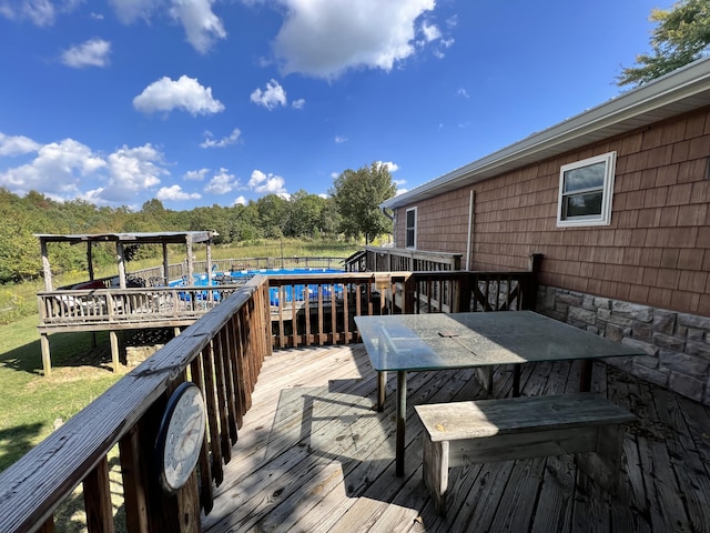 wooden terrace with outdoor dining area
