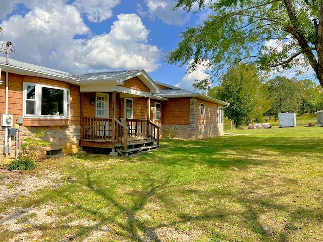 view of front of home with stone siding and a front yard