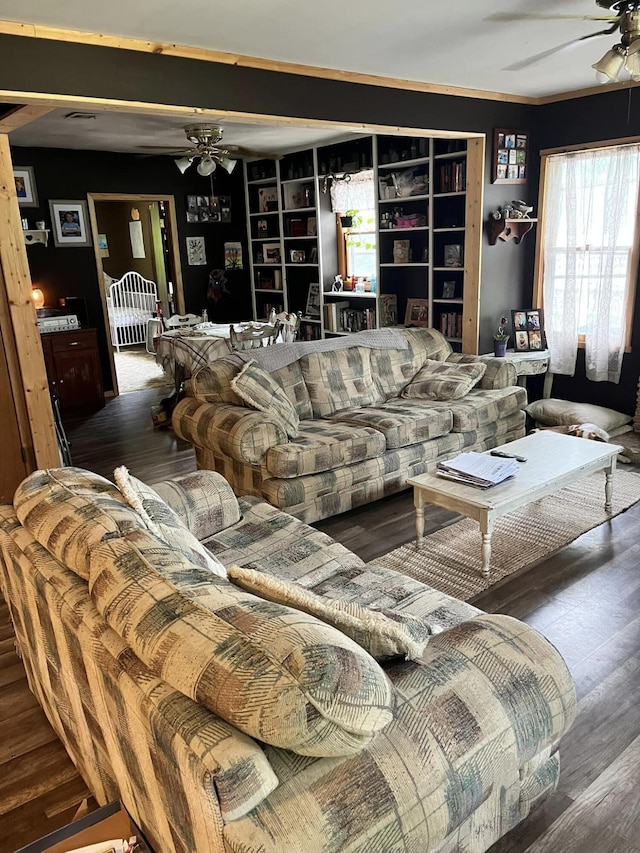 living room featuring ceiling fan and dark hardwood / wood-style floors