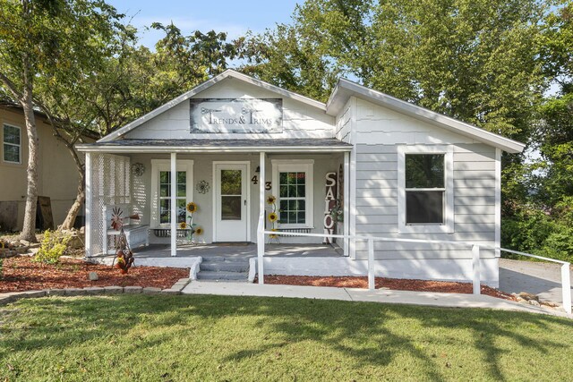 bungalow with a porch and a front yard