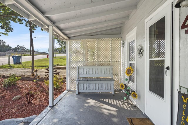 sunroom / solarium featuring lofted ceiling