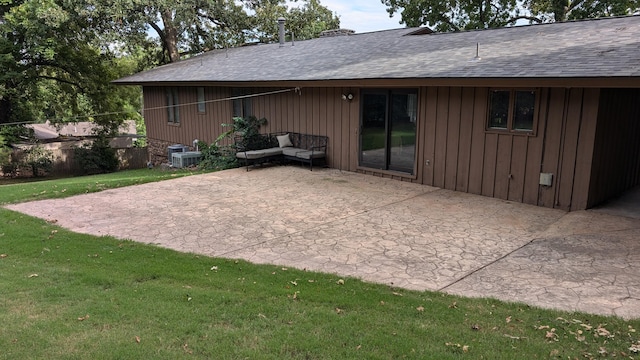 rear view of house with a lawn and a patio area