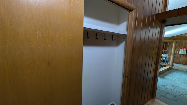 mudroom with wooden walls