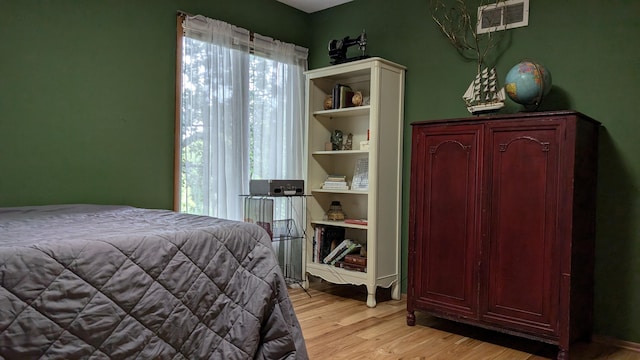 bedroom with light wood-type flooring and multiple windows