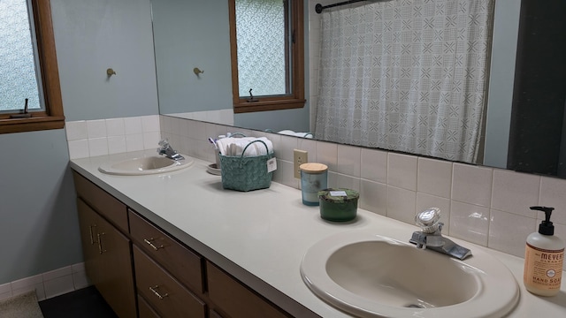 bathroom with tasteful backsplash and vanity