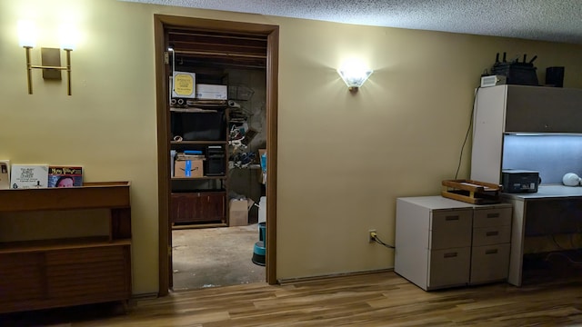 home office featuring a textured ceiling and light wood-type flooring